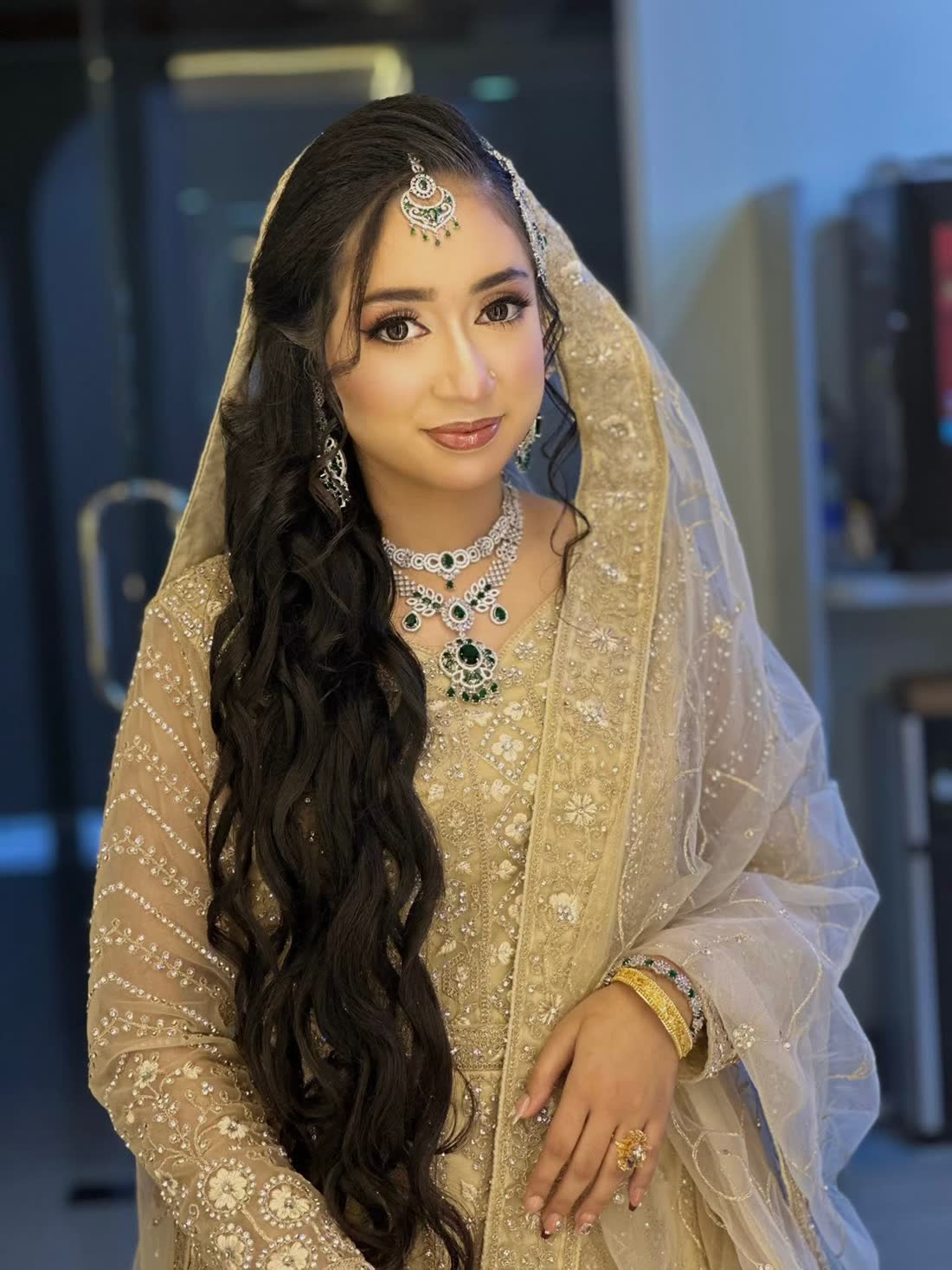 A bride in full wedding jewellery and makeup